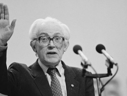 Michael Foot behind a microphone
