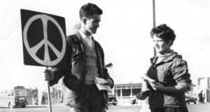 1950s peace activists holding a placard displaying the CND symbol