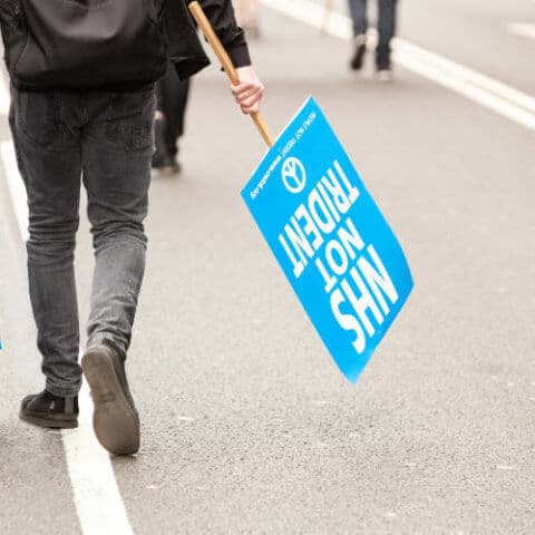 Protestor with NHS not Trident placards