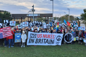 CND supporters gather behing a banner that reads "No US nukes in Britain"