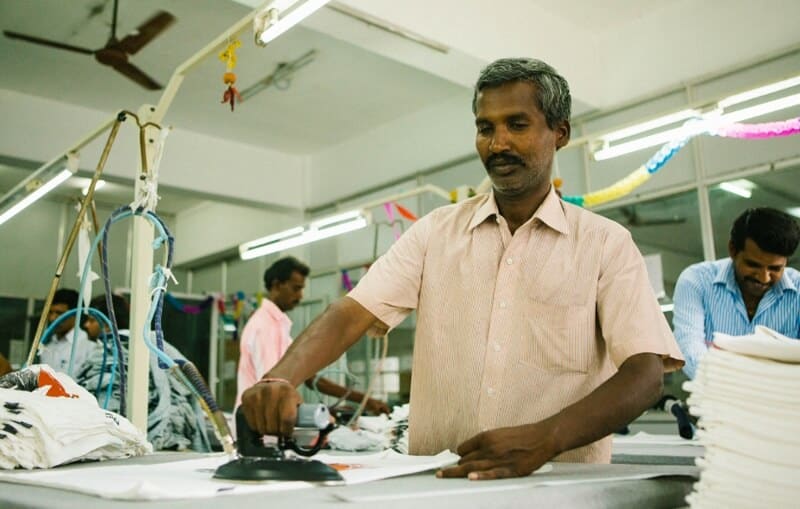A worker puts the finishing touches on a T-shirt made from organic cotton at our renewable-powered garment factory